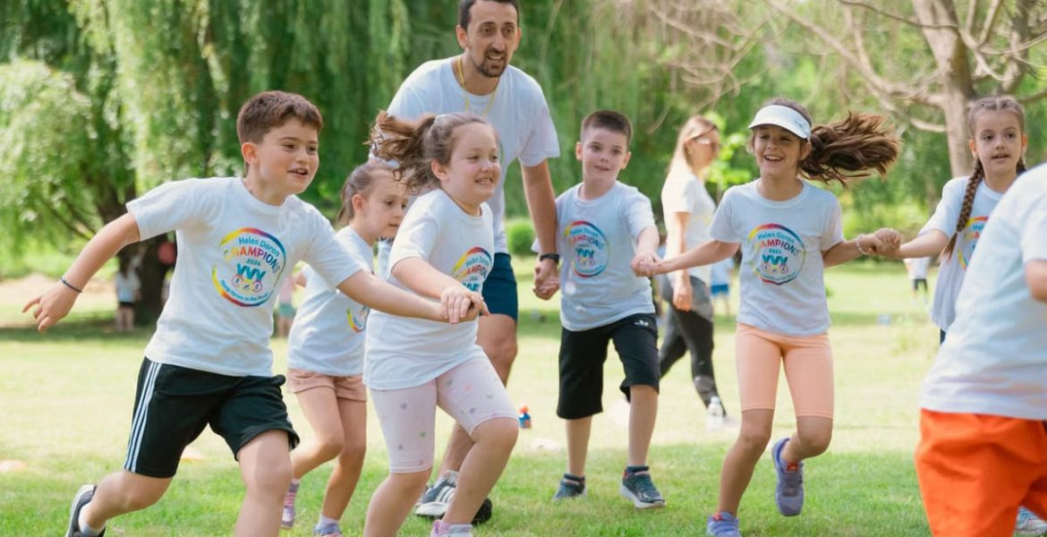 Children joyfully running and holding hands in a sunny park, enjoying outdoor recreation.